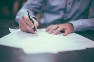 Man signing LOA
