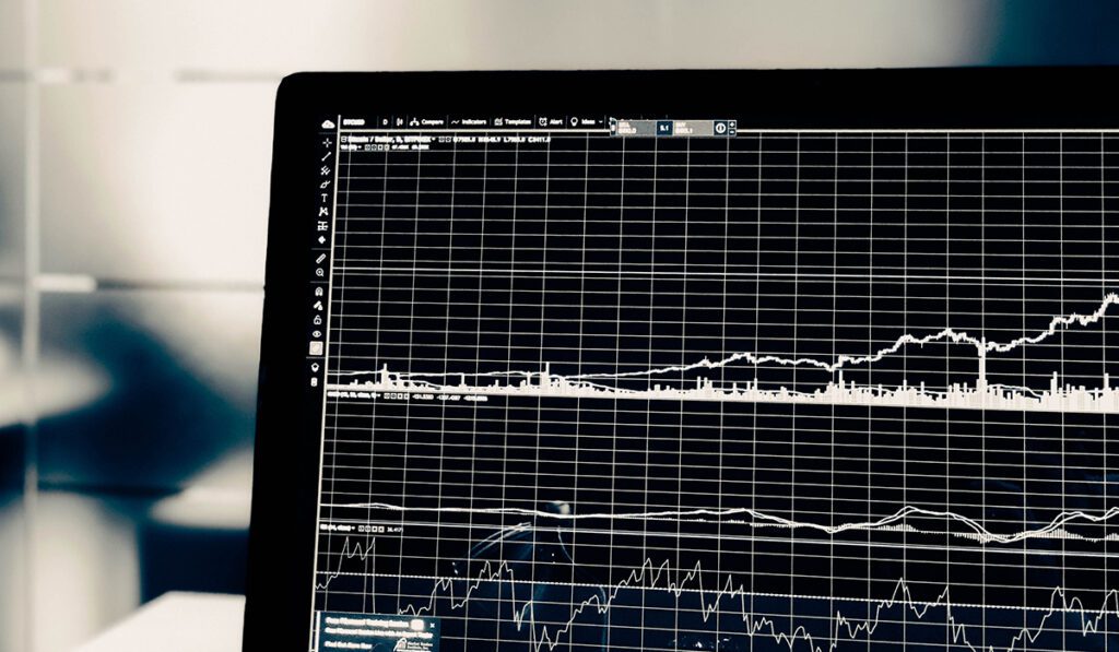 Business energy market graphs showing increases on a black screen