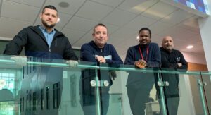 Four new starters for the Procure Smart Launchpad standing behind a glass ballustrade