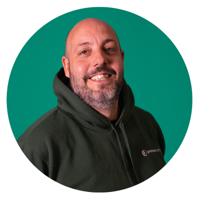 A Procure Smart employee smiling in a teal circle frame